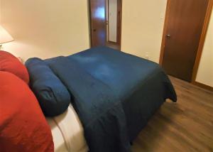 a blue blanket laying on top of a bed at A Frame of Mind in Red River +28 photos