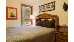 a bedroom with a large bed and a window at Twining 7 in Taos Ski Valley