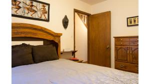 a bedroom with a bed and a wooden headboard at Twining 7 in Taos Ski Valley