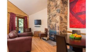 a living room with a table and a fireplace at Twining 7 in Taos Ski Valley +10 photos