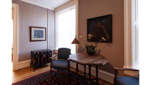 a living room with a table and a painting on the wall at Waite Phillips in Cimarron