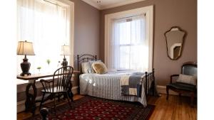 a bedroom with a bed and a table and a mirror at Waite Phillips in Cimarron