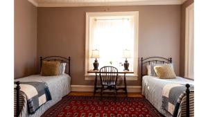 two beds in a room with a window at Waite Phillips in Cimarron +4 photos