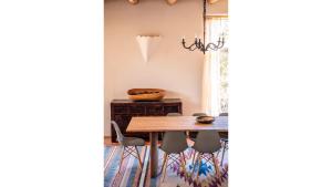 a dining room with a wooden table and chairs at Casa Angel in Valdez