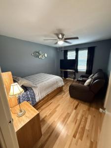 a bedroom with a bed and a couch at The Loft in McKinney