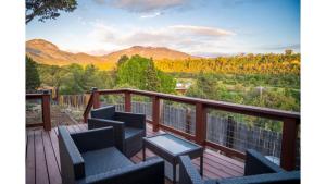 a balcony with chairs and a view of mountains at Casa Angel in Valdez