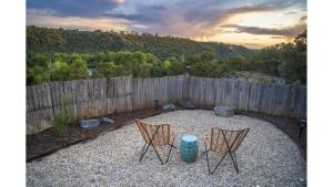 two chairs and a table in a yard with a fence at Casa Angel in Valdez +26 photos