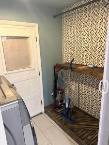 a laundry room with a door with a mop at The Loft in McKinney