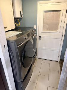 a washing machine in a kitchen with a door at The Loft in McKinney