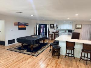 a living room with a table and a kitchen at The Loft in McKinney