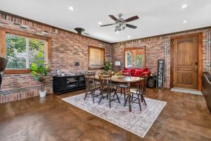 a dining room with a table and chairs and a brick wall at Beaver Lake Hideaway in Lowell