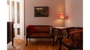 a living room with a chair and a table at Bat Masterson in Cimarron