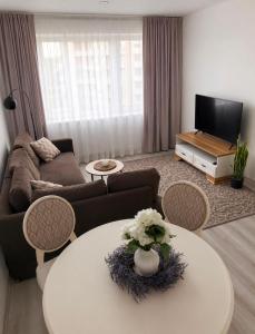 a living room with a couch and a table at Mis apartamentai in Mažeikiai