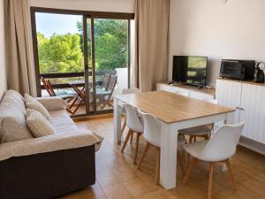 a living room with a table and a couch at Formenterasuite 16 in Es Pujols