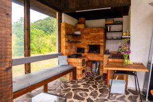 a room with a bench and a table and a stove at K-Home in Stănija