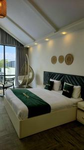 a bedroom with a large bed and a balcony at Madrid Luxury Villa in Al Rama