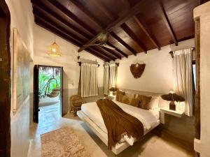 a bedroom with a large bed in a room at Palm Grove Beach Resort in Mandrem +67 photos
