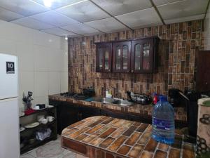 a kitchen with a bottle of water sitting on a table at La casa de Juana in Las Tablas +5 photos