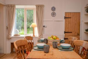 a dining room table with a bowl of fruit on it at Darroch Beag in Saint Catherines