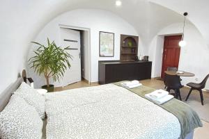 a bedroom with a large bed and a table and chairs at #RYNEK stare miasto MKVADRAT in Lublin