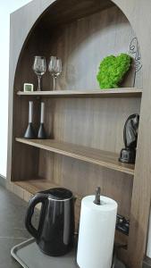 a kitchen counter with a coffee pot and wine glasses at #RYNEK stare miasto MKVADRAT in Lublin