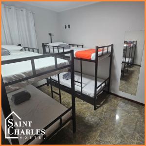 a group of bunk beds in a room at Saint Charles Hostel in São Carlos
