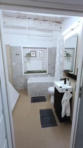 a bathroom with a tub and a toilet and a sink at #RYNEK stare miasto MKVADRAT in Lublin +6 photos