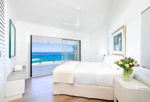 a bedroom with a bed and a view of the ocean at Ocean Panorama With Private Pool! in Noosa Heads