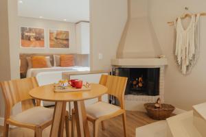 a living room with a table and chairs and a fireplace at Cabanas Belo Destino in Gramado