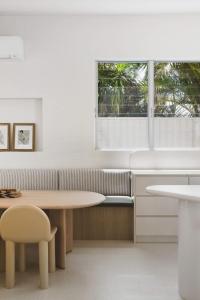 a kitchen with a table and a chair and a window at Coastal Haven on Witta in Noosa Heads