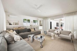 a living room with a couch and a table at Coastal Haven on Witta in Noosa Heads