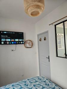 a bedroom with a bed and a tv on the ceiling at Le coeur de Mers in Mers-les-Bains