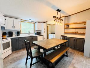 a kitchen with a wooden table and chairs at Put-in-Bay Island Club #71 in Put-in-Bay