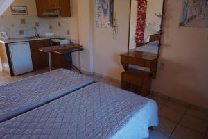 a room with two beds and a kitchen with a sink at Kapitan in Arillas