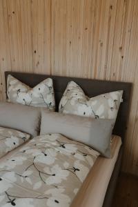 a bed with two pillows on top of it at Natururlaub by Klotz TINY HAUS b in Überlingen
