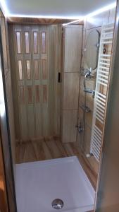a small bathroom with a shower and a toilet at Chata Milka in Medzilaborce