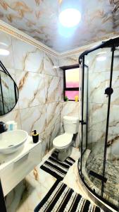 a bathroom with a toilet and a sink at Blairgowrie Skyline in Johannesburg +111 photos