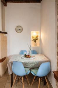 a dining room table with blue chairs and a table cloth at Traditional House in Laerma in Láerma
