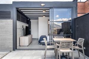 a patio with a table and chairs on a balcony at Park 38 in Envigado