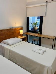 a bedroom with a large bed and a window at Requinte Hotel in São Paulo +26 photos