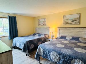 a bedroom with two beds and a window at Put-in-Bay Poolview Condo #4 in Put-in-Bay
