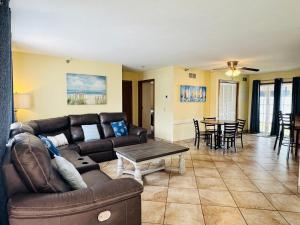 a living room with a couch and a table at Put-in-Bay Poolview Condo #4 in Put-in-Bay