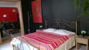 a bedroom with a bed with a striped bedspread at Home Sweet Home in Riga