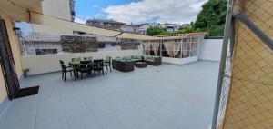 a patio with a table and chairs on a balcony at Casa LuzValle in Arenas de San Pedro