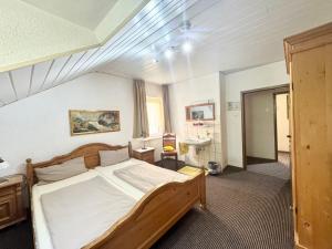 a bedroom with a bed and a sink in it at Hotel Bauernstube in Oberhausen