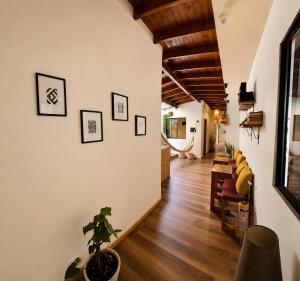 a hallway with white walls and wooden ceilings at Luum Guest House Manila in Medellín