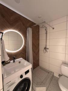 a bathroom with a washing machine and a toilet at Central House in Cahul
