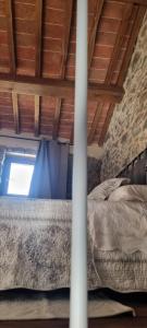 a bedroom with a bed under a wooden ceiling at Tuscany House Retreat in Casentino in Subbiano