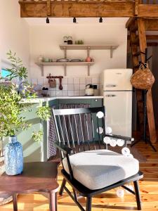 a kitchen with a chair and a refrigerator at POLANKA - Krzynki 16A in Krzynki