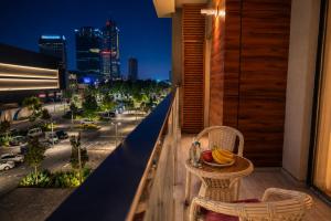 a balcony with a view of a city at night at 7 Star Apartments in Tashkent